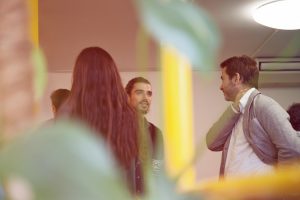 Professionals networking at a collaborative office space.