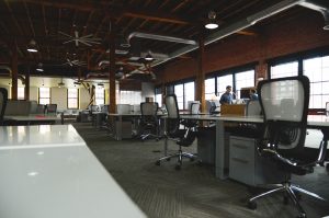 A number of empty workspaces in a coworking space.