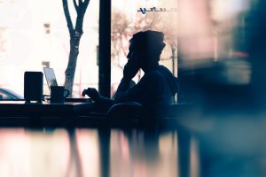 A man on the phone in a coffee shop.