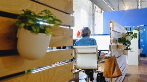 A woman in a private office of a coworking space.