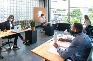 People working from a coworking space with masks on.
