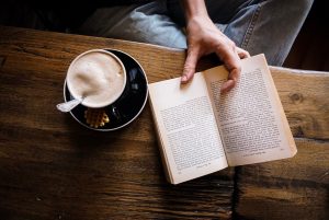 An image of a book and a cup of coffee.