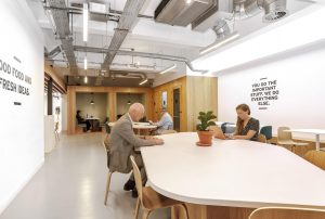 Two people coworking from a Spaces location.