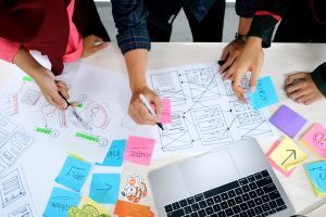 A group of people working on a project in a flex office space.