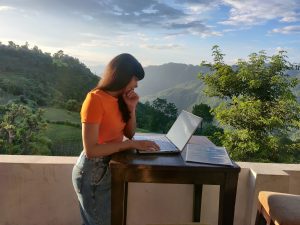 A digital nomad working with her laptop outside.
