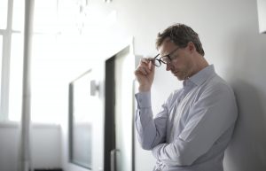 A man feeling stressed at work.