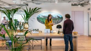 A woman and man speaking in a sustainable coworking space