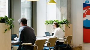 A group of people working on a project in a flex office space.